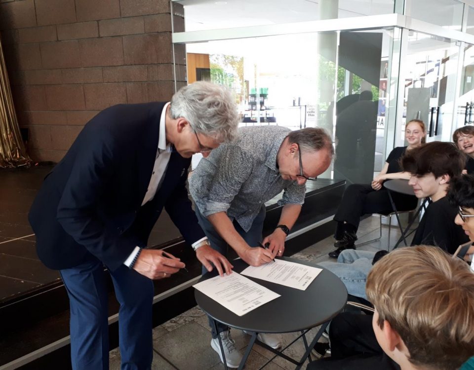 Der schulleiter beugt sich in der gruppe über ein formulars